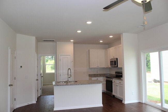 Building Photo - Sun-Filled 3-Story End-Unit Townhome with Fenced Yard, Storage & Resort-Style Pool