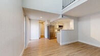 Located at 1121 W Prospect Rd in Fort Collins, Colorado, this two-story, one-bedroom, two-bathroom home offers a well-designed layout across two floors. The main level features an open-concept living area with light hardwood-style flooring that flows throughout, creating a bright and cohesive feel. The kitchen is highlighted by white cabinetry, stainless steel appliances including a refrigerator and microwave, and a peninsula that opens to the living space — ideal for everyday functionality. A dedicated laundry room with a stacked washer and dryer unit adds in-unit convenience. One of the standout architectural elements is a striking black spiral staircase that leads to the upper level, adding a bold visual focal point to the main floor. The upper level houses the bedroom, which features plush carpeting, neutral tones, and a window that brings in natural light. Two bathrooms serve the home, one of which features classic white subway tile surrounding a full tub-shower combo, a gray vanity, and wood-style flooring. Additional spaces include a hallway, closet, and dedicated laundry room, ensuring ample storage and organization throughout. The overall ambiance is clean, modern, and move-in ready.