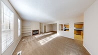 Located at 7360 W Cross Creek Trail in Brecksville, Ohio, this single-story, 3-bedroom, 2-bathroom home offers a generous and well-organized floor plan. The expansive living room is a standout feature, highlighted by a brick fireplace flanked by built-in shelving units — ideal for display and storage — and bathed in natural light through large windows. Neutral-toned carpet flows throughout the living areas and bedrooms, complementing the warm, inviting ambiance. A pass-through window connects the living room to the kitchen, which is outfitted with honey-toned oak cabinetry, dark granite countertops, tile flooring, and stainless steel appliances including a full-size refrigerator. The spacious primary bedroom features multiple windows that fill the room with sunlight and provides access to a well-appointed en-suite bathroom complete with warm wood vanity cabinetry, dark granite countertops, and a large mirror with overhead lighting. The additional bedrooms are carpeted and offer ample natural light. A utility room and dedicated closet add functional storage. The home also includes an attached garage with an automatic opener, providing convenient and secure parking. Textured ceilings are consistent throughout, adding a classic finishing touch to this comfortable Brecksville home.