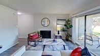 This 600 square foot apartment in Carrolton, TX, offers a thoughtful layout maximizing space and functionality. The single-floor plan includes one bedroom, two full bathrooms, and an open-concept living area. The primary bedroom, measuring 150 square feet, provides ample space and features a large window for natural light.

The modern kitchen boasts white cabinetry, stainless steel appliances, and a stylish backsplash. It's equipped with a full-size refrigerator, dishwasher, and built-in microwave, perfect for preparing meals efficiently. The living room is anchored by a sleek fireplace and offers a cozy seating area with contemporary furnishings. Large windows and sliding glass doors lead to an outdoor space, bringing in natural light and extending the living area.

Both bathrooms are well-appointed, featuring modern fixtures, ample storage, and a combination of shower and bathtub options. The apartment also includes in-unit laundry facilities, adding convenience to daily living. Throughout the space, neutral tones and wood-look flooring create a cohesive, contemporary aesthetic. This apartment combines comfort and style, ideal for those seeking a modern urban living experience.