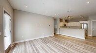 Located at 11 Lafayette Dr. in New Windsor, NY, this well-appointed 2-bedroom, 2-bathroom home offers a thoughtfully designed single-floor layout with modern finishes throughout. Light wood-look flooring flows consistently across the living spaces, complementing the neutral gray-toned walls and clean white trim.

The open-concept kitchen and living area serves as the heart of the home, featuring white shaker cabinetry, a large kitchen island with a gray quartz countertop, stainless steel appliances including a full-size refrigerator and built-in microwave, and recessed lighting overhead. The combined layout creates an inviting, functional space for everyday living.

The generously sized primary bedroom offers abundant natural light through large windows with blinds, recessed lighting, and access to a spacious walk-in closet outfitted with wire shelving. The en-suite bathroom is finished with floor-to-ceiling subway tile, a frameless glass walk-in shower with a built-in bench, and marble-look tile flooring. The second bedroom is equally well-proportioned, also featuring light wood flooring and natural light. The second bathroom includes a soaking tub with tiled surround, a dark-wood vanity with white countertop, and marble-look flooring. A dedicated in-unit laundry room with wire shelving and washer hookups adds everyday convenience.