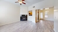 This two-story residence in Bakersfield, CA, offers 1090 square feet of living space, thoughtfully divided between 720 sq ft on the ground floor and 370 sq ft upstairs. The home boasts three bedrooms, including a primary bedroom of 160 sq ft, and three full bathrooms. The interior showcases a blend of modern finishes, with wood-look flooring throughout most rooms and carpeting in select areas.

The kitchen features honey-colored cabinetry, black appliances, and a practical U-shaped layout. The living area is enhanced by a built-in fireplace, creating a cozy atmosphere. Bathrooms are equipped with white fixtures and some include wooden vanities with granite countertops. Ceiling fans in bedrooms and living spaces provide additional comfort.

Large windows in various rooms allow for ample natural light, while the neutral wall colors throughout maintain a bright, airy feel. The home includes a garage with a concrete floor and a small outdoor patio area. The exterior is characterized by stucco walls and a tiled roof, typical of the region's architectural style. This property combines functionality with modern aesthetics, offering a comfortable living space in a desirable Bakersfield location.