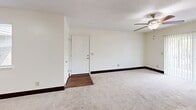Located at 106 Castle Dr in Dothan, Alabama, this single-story, 3-bedroom, 1-bathroom home offers a practical and straightforward layout. The interior is finished with neutral tones and dark baseboards throughout, creating a clean, cohesive aesthetic.

The spacious primary bedroom is notably generous in size, featuring plush carpet flooring, a ceiling fan with light fixture, and two closets—including a double sliding-door closet—providing ample storage. An en-suite connection leads directly to the bathroom. The two additional bedrooms are comfortably sized, each equipped with ceiling fans and windows that allow natural light and outdoor views.

The kitchen is efficiently designed with rich, dark wood cabinetry, granite-look countertops, a tile mosaic backsplash, a black electric range, and a double stainless steel sink. Wood-look flooring adds warmth and durability to this functional space.

The full bathroom includes a tub/shower combination, a wood-look floor, and a vanity with granite-look countertops, maintaining consistent finishes with the rest of the home.

The living area features carpet flooring, ceiling fans, and direct access via a paneled front entry door. A hallway connects the main living spaces to the bedrooms and bathroom, keeping the layout organized and efficient.