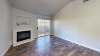 Located at 1000 Cirby Oaks Way in Roseville, CA, this single-story, 3-bedroom, 2-bathroom home offers a well-organized layout with clean, modern finishes throughout. The living room serves as the heart of the home, featuring vaulted ceilings, rich wood-look flooring, a classic brick fireplace, and a sliding glass door that fills the space with natural light and provides outdoor access. The galley-style kitchen is thoughtfully designed with crisp white shaker cabinetry, quartz countertops, a stainless steel sink, and stainless steel appliances including a dishwasher, range, and microwave. Natural light filters in through window blinds, enhancing the bright, airy atmosphere. The three bedrooms are finished with wood-look flooring and soft neutral walls. Several bedrooms feature sliding mirrored closet doors and windows with views of surrounding greenery. Hallways with mirrored closets connect the bedrooms to the two bathrooms. The bathrooms are well-appointed with white vanities, quartz countertops, and wood-look flooring. One bath includes a walk-in shower, while the other offers a tub-shower combination with white tile surround. The home's cohesive, light-filled design and functional layout make it an efficient and comfortable living space.