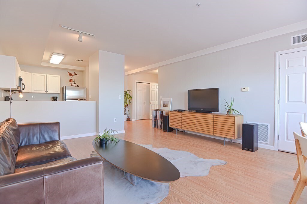 Large public living area connected to kitchen. - 1 Cityview Ln