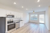 Located at 233 W 26th St in Chattanooga, TN, this thoughtfully designed one-bedroom, one-bathroom unit offers a clean, modern aesthetic across a single floor. Light hardwood flooring runs throughout the entire space, creating a cohesive and bright atmosphere.

The open-concept kitchen and living area serves as the heart of the unit. The kitchen features white shaker-style cabinetry, granite countertops, a stainless steel undermount sink, and a full suite of stainless steel appliances including a refrigerator, electric range, microwave, and dishwasher. Recessed lighting illuminates the kitchen, while the living area is anchored by a ceiling fan and benefits from abundant natural light streaming through large windows and a glass door that opens to a private balcony with outdoor views.

The bedroom is a comfortable, well-lit retreat with a ceiling fan, a large window overlooking the outdoors, and direct access to a dedicated closet with built-in shelving. The bathroom is finished with a granite-topped vanity, an undermount sink, and a full soaking tub with shower, all set against a clean white backdrop with continued hardwood-style flooring. The overall ambiance is fresh, modern, and move-in ready.