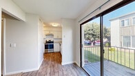 Located at 2011 Richard Jones Rd in Nashville's 37215 zip code, this two-story, 2-bedroom, 4-bathroom home is thoughtfully laid out across two well-proportioned floors. The main level features a carpeted living room filled with natural light from large windows, a dedicated dining area anchored by a stylish gold lantern pendant light, and wood-look flooring that flows throughout the common areas. The kitchen is well-appointed with white cabinetry, subway tile backsplash, granite-style countertops, stainless steel appliances including a dishwasher and range, and a window above the sink for added brightness. Sliding glass doors lead from the main level to a private outdoor patio with pleasant exterior views. Upstairs, the two bedrooms are carpeted and offer ample closet space, with the primary bedroom providing a generous footprint. The four bathrooms are finished with granite-style vanity counters, white cabinetry, wood-look tile flooring, and tiled tub-shower combinations. Additional highlights include multiple closets throughout, a dedicated laundry area, a utility room, and two staircases connecting the floors. Textured ceilings and neutral tones create a clean, move-in-ready ambiance throughout the home.