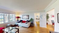 Located at 336 N Garfield Ave in Montebello, CA, this single-story home offers a well-designed layout with warm hardwood flooring flowing throughout the main living areas. The spacious living room is bathed in natural light from large picture windows that frame views of the surrounding greenery, complemented by crown molding along the ceiling and a generous open feel. A versatile secondary room with corner windows and a ceiling fan serves well as a home office or sitting area, offering ample brightness and a functional workspace. The dining area features elegant crown molding, a classic chandelier, and a window that invites natural light, creating a welcoming setting for meals. The kitchen is equipped with warm wood cabinetry, dark granite countertops, and black appliances including a gas range and over-the-range microwave, providing both style and practicality. The bedroom is a restful retreat with hardwood floors, a ceiling fan, and soft window treatments that diffuse natural light. The bathroom includes a granite-topped vanity with wood cabinetry, tile flooring, and a tub-shower combination with a window for ventilation. Throughout the home, a consistent use of hardwood floors, neutral tones, and natural light creates a cohesive and inviting atmosphere.