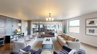 Located in Chicago's vibrant Uptown neighborhood, this single-floor amenity space at 1133 W Lawrence Ave offers a thoughtfully designed environment for gathering and recreation. The open-concept layout connects multiple seating areas through a fluid, expansive floor plan anchored by polished concrete floors that reflect natural light throughout.

The main lounge area features a sophisticated mix of tufted leather sofas, neutral upholstered seating, and a modern globe chandelier, all framed by large windows offering striking city views. Exposed structural beams add an industrial character that complements the contemporary furnishings. A second lounge area showcases textured gold ceilings, a velvet sofa, and large sliding glass doors that open directly onto an outdoor terrace with seating.

The full kitchen is outfitted with stainless steel appliances, white cabinetry, a central island with bar seating, and pendant lighting, making it well-suited for catering or communal use. Adjacent to this is a casual dining area. A dedicated game zone features a shuffleboard table beneath a linear chandelier, surrounded by lush tropical plants. The welcoming entry foyer offers additional lounge seating and direct access to the terrace, completing a well-rounded, amenity-rich space.