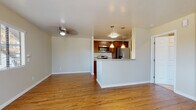 Located at 1379 27th St in San Diego, CA, this single-floor residence offers a thoughtfully designed layout that balances functionality with comfort. The open-concept living and dining area is finished with warm hardwood-style flooring and neutral-toned walls, creating a bright and welcoming atmosphere. A ceiling fan adds practical comfort to the living space, while natural light flows in through windows fitted with horizontal blinds.

The kitchen is a standout feature, boasting rich dark-wood cabinetry, granite-style countertops, and a full suite of stainless steel appliances including a refrigerator, range, and built-in microwave. A peninsula with pendant lighting overhead serves as a natural divider between the kitchen and living area, offering additional counter space and an informal seating option.

The bedroom is carpeted for warmth and comfort, with a window providing views of the surrounding neighborhood and ample natural light. The bathroom is well-appointed with a rich wood vanity, granite countertop, an undermount sink with brushed nickel fixtures, and dual mirrors above.

Throughout the home, the clean, neutral palette and quality finishes create a cohesive and move-in-ready environment suited to a variety of lifestyles.