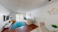 Located at 250 W Sample Rd in Pompano Beach, Florida, this well-appointed 2-bedroom, 2-bathroom residence offers a comfortable and functional single-floor layout. The open-concept living and dining area serves as the heart of the home, featuring rich hardwood-style flooring, a textured ceiling, and a bright, airy atmosphere. Sliding glass doors lead to a private balcony, allowing natural light to flood the space and providing a seamless indoor-outdoor connection. The kitchen is thoughtfully designed with warm wood cabinetry, granite countertops, a granite tile backsplash, and stainless steel appliances, including a dishwasher and range. The primary bedroom is generously sized, finished with plush carpeting, built-in closet storage, and a serene, neutral palette. A spacious walk-in closet provides exceptional storage. The second bedroom is equally well-proportioned with its own closet space. Two full bathrooms serve the home — one featuring a sleek glass-enclosed shower with mosaic tile flooring, and the other a full tub-shower combination with white tile surround. Three closets throughout the residence ensure abundant storage. The overall ambiance is clean, bright, and move-in ready.