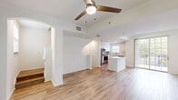 Located at 11772 SW 26th Ct in Miramar, Florida, this three-story townhouse offers 2 bedrooms and 2 bathrooms across well-organized floors. The ground level houses an attached garage with an automatic opener, a painted concrete floor, and an interior access door — providing both secure parking and convenient entry. The main living level features an open-concept layout where the kitchen flows seamlessly into the living area. The kitchen is equipped with stainless steel appliances, including a refrigerator, range, and built-in microwave, complemented by white shaker cabinets, a tiled backsplash, and a central island with a white countertop. Light wood-tone flooring extends throughout the main and upper levels, creating a warm and cohesive aesthetic. Arched architectural details and ceiling fans add character to the living spaces. Natural light filters in through multiple windows, enhancing the bright, airy ambiance. The upper floor hosts both bedrooms, each featuring ceiling fans and windows with outdoor views. The spacious primary bedroom includes direct access to an en-suite bathroom. Both bathrooms feature tub-shower combinations with white tile surrounds accented by diamond-pattern inlays. The overall design is clean, functional, and well-suited for comfortable everyday living.