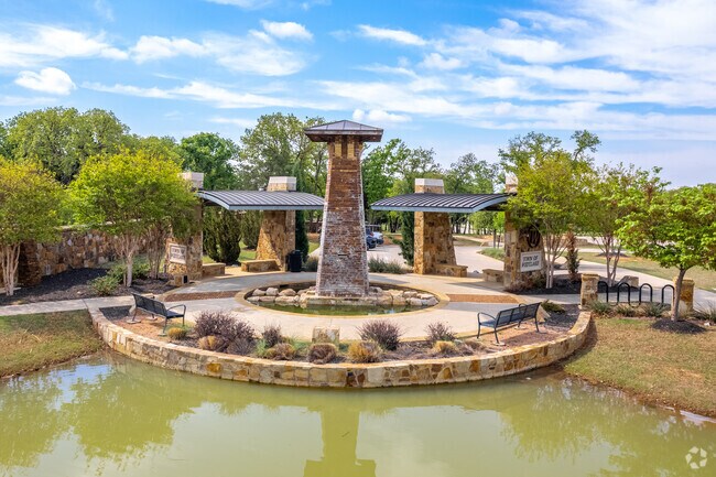 Westlake Fountain is a beautiful green space with a fountain and shaded seating.