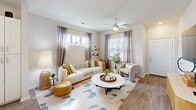 Located at 270 Wild Palm Way in Conway, SC, this two-story home offers a thoughtfully designed layout spread across two floors. The main level is anchored by an open-concept kitchen and living area bathed in natural light from multiple windows. The kitchen is outfitted with white shaker cabinets, granite countertops, a subway tile backsplash, stainless steel appliances, and a central island with open shelving — ideal for both cooking and casual dining. Light wood-look flooring flows seamlessly throughout the main level, enhancing the bright and airy atmosphere. The living room is generously proportioned, featuring a ceiling fan, large windows with decorative draping, and a coastal-inspired aesthetic that gives the space a relaxed, welcoming feel. Upstairs, the primary bedroom provides a comfortable retreat with plush carpeting, a ceiling fan, and ample natural light. Its en-suite bathroom includes a granite-topped vanity, a glass-enclosed walk-in shower, and direct access to a dedicated walk-in closet. The second bedroom is equally well-appointed with soft carpet and warm neutral tones. A full second bathroom with a tub-shower combo, granite vanity, and wood-look flooring serves the additional bedroom. Two closets provide practical storage throughout the home.