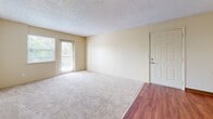Located at 856 S Van Gordon Ct in Lakewood, Colorado, this two-bedroom, two-bathroom residence is thoughtfully arranged on a single floor. The layout connects all rooms via a central hallway, creating an efficient and easy-to-navigate flow throughout the home.

The living room is a comfortably sized, open area featuring plush carpeting, warm neutral walls, a textured ceiling, and a glass door that opens to a private balcony, allowing natural light to filter in and providing outdoor views of surrounding greenery.

The kitchen runs in a galley-style configuration with warm wood-toned cabinetry, dark countertops, a full suite of black appliances including a refrigerator and range, and wood-look flooring. Track lighting and a raised breakfast bar add both functionality and character to the space.

Both bedrooms are carpeted and feature neutral, light-toned walls and windows with blinds that offer a view of mature trees outside. The primary bedroom provides a generous amount of space, while the secondary bedroom is well-proportioned and versatile.

The bathrooms include wood-look flooring, warm cabinetry with countertop vanities, large mirrors, and well-lit fixtures. The hallways connect the rooms cleanly, with wood-look flooring carrying the cohesive aesthetic throughout the unit.
