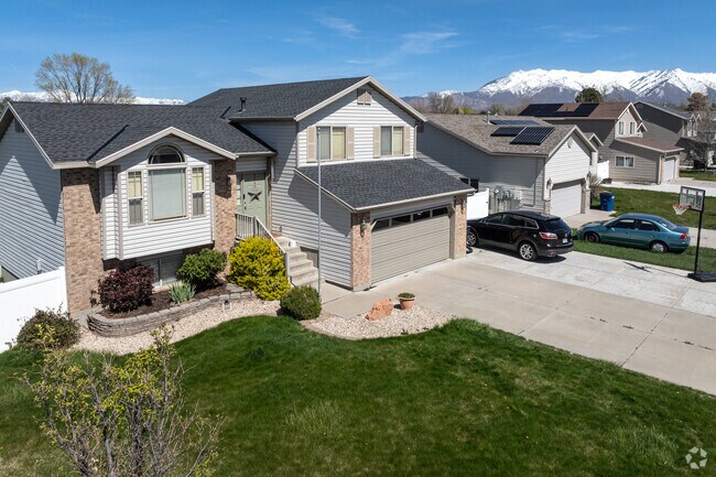 Two-story homes sit on a quiet street with mountain views in Clinton.