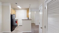 This well-appointed 2-bedroom, 2-bathroom single-story residence in West Columbia, SC offers a functional and comfortable layout across its single floor. The kitchen serves as a central highlight, featuring light wood cabinetry, granite-style countertops, black appliances including a refrigerator and range, and a peninsula breakfast bar accented by stylish pendant lighting. A skylight floods the kitchen with natural light, creating a bright and inviting atmosphere. Wood-style flooring runs throughout the main living and kitchen areas, adding warmth and easy maintenance.

Both bedrooms are carpeted for comfort and include ceiling fans and windows with horizontal blinds that provide natural light and outdoor views. The primary bedroom offers a generous footprint with its own dedicated closet. A hallway connects the rooms efficiently, with two closets providing ample storage throughout.

The two bathrooms are thoughtfully designed — one features a walk-in shower with a framed glass door, while the other includes a full tub-shower combination, both with wood-toned cabinetry and granite-style countertops. The overall color palette throughout the home is neutral and bright, with light walls and clean finishes that create a cohesive, move-in-ready aesthetic.