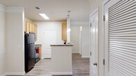 This well-appointed 2-bedroom, 2-bathroom single-story residence in West Columbia, SC offers a functional and comfortable layout across its single floor. The kitchen serves as a central highlight, featuring light wood cabinetry, granite-style countertops, black appliances including a refrigerator and range, and a peninsula breakfast bar accented by stylish pendant lighting. A skylight floods the kitchen with natural light, creating a bright and inviting atmosphere. Wood-style flooring runs throughout the main living and kitchen areas, adding warmth and easy maintenance.

Both bedrooms are carpeted for comfort and include ceiling fans and windows with horizontal blinds that provide natural light and outdoor views. The primary bedroom offers a generous footprint with its own dedicated closet. A hallway connects the rooms efficiently, with two closets providing ample storage throughout.

The two bathrooms are thoughtfully designed — one features a walk-in shower with a framed glass door, while the other includes a full tub-shower combination, both with wood-toned cabinetry and granite-style countertops. The overall color palette throughout the home is neutral and bright, with light walls and clean finishes that create a cohesive, move-in-ready aesthetic.