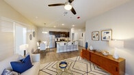 Located in Hammond, Louisiana, this single-story, 3-bedroom, 2-bathroom home offers a thoughtfully designed open-concept layout that seamlessly connects the kitchen, dining, and living areas. The kitchen is a standout feature, boasting dark espresso cabinetry, granite countertops, a stainless steel appliance suite including a refrigerator, microwave, and range, and a central island with bar seating — ideal for both casual dining and entertaining. Recessed and pendant lighting illuminate the space with a clean, modern feel. The living room is bright and welcoming, with wood-look flooring throughout and French doors that invite abundant natural light and provide outdoor access. Ceiling fans are present in both the living area and bedrooms for added comfort. The bedrooms are comfortably sized, with the primary bedroom offering natural light through large windows. Both bathrooms are finished with granite-top vanities and dark cabinetry; one features a double-sink vanity, while the other includes a tub-shower combination. A dedicated walk-in closet provides organized storage, and an in-unit laundry room with a full-size washer and dryer adds everyday convenience. Light-toned walls and consistent flooring unify the home's clean, contemporary aesthetic throughout.