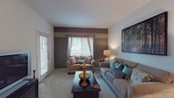 This 1-bedroom, 1-bathroom residence is thoughtfully laid out across a single floor, making efficient use of every square foot. The living room serves as the heart of the home, featuring plush carpeting, a bold accent wall with contrasting neutral tones, and windows with blinds that allow natural light to filter in. The space comfortably accommodates a full seating arrangement, making it ideal for relaxing or entertaining.

Adjacent to the living area is a dedicated dining space, which connects seamlessly to the galley-style kitchen. The kitchen features wood-look flooring, white cabinetry with ample storage, a double-basin stainless steel sink, a dishwasher, and an electric range—providing all the essentials in a compact, functional layout.

The bedroom offers carpeted flooring, a window with natural light, closet access, and a decorative accent wall that carries through the home's cohesive color palette. The full bathroom includes a tub/shower combination with white tile surround, wood-look flooring, and a vanity with counter storage.

Throughout the residence, a consistent design aesthetic of earth tones, bold accent walls, and a mix of soft and hard flooring surfaces creates a warm and inviting atmosphere.