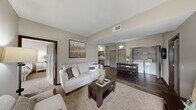 This well-appointed two-bedroom, two-bathroom residence in Billings, Montana offers a thoughtfully designed single-level layout that maximizes comfort and functionality. The open-concept living and dining area serves as the heart of the home, featuring warm wood-look flooring, neutral toned walls, and vaulted ceiling details that create an airy, inviting atmosphere. The living area flows seamlessly into the dining space and kitchen, making it ideal for everyday living and entertaining.

The kitchen is a standout feature, boasting rich dark-toned cabinetry, striking granite countertops, stainless steel appliances, and a central island with bar seating and pendant lighting overhead — combining style with practicality. A dedicated in-unit laundry area is conveniently located just off the main living space.

Both bedrooms are well-sized and carpeted for comfort, with the primary bedroom offering access to a private bathroom featuring granite countertops, dark wood cabinetry, and elegant lighting fixtures. Each bedroom benefits from generous closet space, including a walk-in closet outfitted with wire shelving systems for organized storage. Natural light flows through the bedroom windows, adding warmth to the neutral, calming palette found throughout the entire residence.