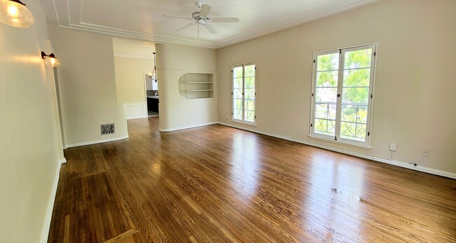 Living room with tall french windows. - 1001 S Holt Ave