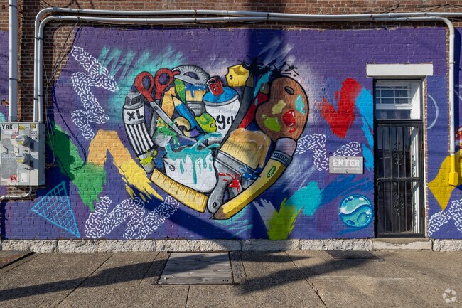 This colorful mural depicts art supplies in Shelby Park.