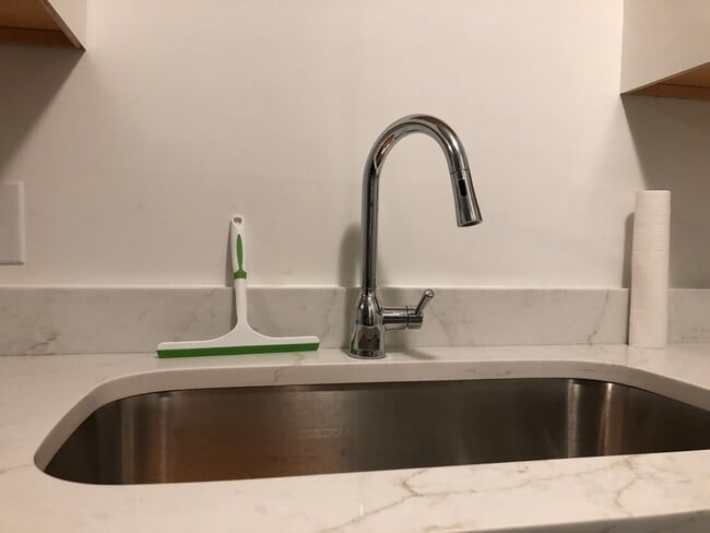 Updated kitchen sink with new faucet and counter. - 261 Simpson Ave