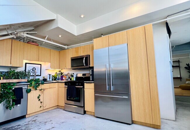 Kitchen with stainless built-in appliances (fridge, stove/oven, microwave, dishwasher) - 200 N San Fernando Rd