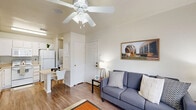 Located at 2001 Holleman Dr W in College Station, TX, this well-designed one-bedroom, one-bathroom unit offers a practical and comfortable single-floor layout. The open-concept living and dining area features wood-style flooring, neutral walls, and a ceiling fan overhead, creating a bright and welcoming atmosphere. A large window invites natural light into the living space, enhancing its airy feel.

The kitchen is outfitted with white cabinetry, a full suite of appliances including a refrigerator, electric range, microwave, and dishwasher, along with ample counter space. An adjacent walk-in pantry provides generous additional storage. A compact dining area with a bistro-style table sits conveniently nearby, and an in-unit laundry area adds everyday convenience.

The bedroom features plush carpeting, a large window with outdoor views, a built-in desk area ideal for studying or working, and a mirrored sliding-door closet with wire shelving. A second closet offers further storage flexibility. The bathroom includes a full tub-shower combination with tile surround and wood-style flooring. Neutral tones and a clean, cohesive design carry throughout the entire unit, making it a functional and comfortable home.