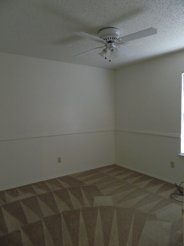bedroom adjacent to master. The third bedroom is adjacent to the second and it tiled - 7806-A Chimayo Cv.