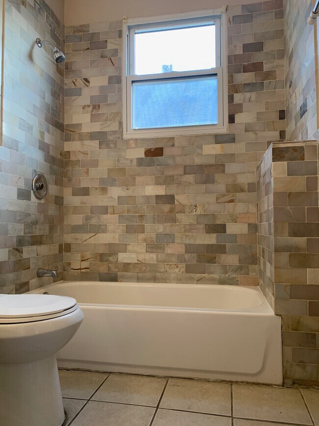 Textured mosaic tiles in common bath - 69 Schley St