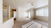 Located at 2155 E Liberty Ln in Phoenix, AZ, this single-floor home offers a comfortable and functional layout designed for everyday living. The spacious living area is bathed in natural light streaming through large windows fitted with vertical blinds, and is accented by crown molding and a ceiling fan with a light fixture. Plush wall-to-wall carpeting runs throughout the living spaces and bedrooms, lending a warm and inviting feel. A sliding glass door in one of the rooms provides direct outdoor access and additional natural light.

The kitchen is well-equipped with stainless steel appliances, including a refrigerator, electric range, and microwave. Light wood cabinetry provides generous storage, while a light-toned countertop extends to a peninsula-style breakfast bar. A dedicated pantry with built-in shelving adds practical storage capacity, and durable wood-style flooring completes the kitchen's clean aesthetic.

The bedrooms are generously proportioned with soft carpeting, ceiling fans, and ample natural light. Built-in shelving in one room adds a versatile touch. The bathroom features a tub/shower combination, a vanity with light stone countertops, white cabinetry, and wood-style flooring, offering a tidy and functional space.