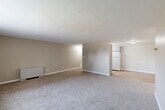 Located at 4155 E Florida Ave in Denver, CO, this 2-bedroom, 1-bathroom unit offers a practical and well-organized single-floor layout. The open-concept living, dining, and kitchen area forms the heart of the home, featuring plush carpeting in the living and dining zones that transitions to hard-surface flooring in the kitchen. The kitchen is equipped with white cabinetry and a full-size refrigerator, keeping the space clean and functional. A wall-mounted heating unit ensures year-round comfort in the main living area.

Both bedrooms are carpeted and finished with warm neutral tones, each featuring vertical-blind windows that allow natural light to filter in. The primary bedroom offers generous proportions and is served by a large sliding-door closet, while the second bedroom similarly features its own closet storage. Multiple additional closets throughout the unit provide ample organization options.

The hallways connect the spaces efficiently, maintaining a cohesive flow throughout the floor plan. The bathroom features a full tub-and-shower combination with clean white tile surround. The overall aesthetic is understated and neutral, with warm beige walls, white trim, and consistent carpeting creating a calm, move-in-ready environment throughout the home.