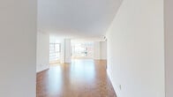 Located in the heart of Toronto's vibrant Church-Wellesley neighbourhood, this well-appointed 3-bedroom, 2-bathroom residence offers a generous and thoughtfully laid-out floor plan. Warm parquet hardwood flooring runs throughout the living areas and all three bedrooms, lending a classic and cohesive aesthetic to the entire space.

The open living room is bright and airy, anchored by expansive floor-to-ceiling windows that frame sweeping views of the Toronto skyline and surrounding green canopy, flooding the space with natural light. The galley-style kitchen is stylishly finished with white cabinetry, granite countertops, a mosaic tile backsplash, and a full suite of stainless steel appliances, combining functionality with a clean modern look.

The generously sized primary bedroom features large windows with city views and a mirrored sliding closet. The two additional bedrooms are well-proportioned, each filled with natural light from their own windows overlooking the cityscape. Both bathrooms are finished in clean white tile — one with a glass-enclosed shower and the other with a soaker tub-shower combination — each accented with dark-framed mirrors for a refined touch. Two hallways and a dedicated closet provide ample storage throughout this well-connected and versatile urban residence.