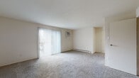 Located at 221 Orville St in Fairborn, Ohio, this single-floor unit offers a practical and well-organized layout throughout. The living area serves as the focal point of the space, featuring neutral carpet flooring, a large sliding glass door dressed with vertical blinds that allows generous natural light and provides access to an outdoor area. A wall-mounted air conditioning unit and baseboard heating ensure year-round climate control.

The kitchen is equipped with white cabinetry offering ample storage, white laminate countertops, a double-basin sink, and a full suite of appliances including a refrigerator, electric range, and dishwasher. Hardwood-style flooring runs through the kitchen, adding a warm contrast to the light-toned cabinetry.

The bedrooms are carpeted and bright, each featuring natural light from windows with blinds. At least one bedroom includes a spacious closet with shelving for organized storage, along with baseboard heating.

The bathroom presents a clean, functional design with a tub/shower combination, vanity with mirrored medicine cabinet, and hardwood-style flooring. A dedicated utility area houses the water heater and features additional hardwood-style flooring. The unit's neutral color palette and straightforward layout offer a versatile living environment.