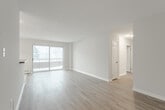 Located at 445 Sugarcreek Trail in London, Ontario, this well-appointed 2-bedroom, 2-bathroom unit offers a comfortable and functional layout across a single floor. The open-concept living and dining area is bright and inviting, featuring light-toned laminate hardwood flooring and large windows and a sliding glass door that fill the space with natural light while providing access to a private balcony with outdoor views of mature trees. The kitchen is thoughtfully designed with white cabinetry, dark countertops, white appliances including a refrigerator, stove, and built-in microwave, and light ceramic tile flooring. A peninsula counter connects the kitchen to the dining area, enhancing the open flow of the space. The generously sized primary bedroom features laminate flooring, a large window with outdoor views, and ample room for furnishings. The second bedroom also features laminate flooring and a closet with bifold doors. Both bathrooms are finished with white tile surround — one featuring a soaker tub and the other a walk-in shower — each with a dark-countered vanity. Neutral grey tones throughout the unit create a clean, cohesive aesthetic that is both modern and welcoming.