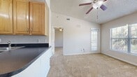 This 460 square foot apartment in Altamonte Springs offers a thoughtful design that maximizes space efficiency. The single-story layout comprises one bedroom, one bathroom, a kitchen, and a living area. The primary bedroom, measuring 130 square feet, provides ample space and includes a walk-in closet with wire shelving for organized storage.

The kitchen is a standout feature, boasting light wood cabinetry, dark countertops, and stainless steel appliances. It includes a refrigerator, stove, microwave, and ample counter space, making it functional for everyday cooking. The L-shaped design creates an open feel, connecting seamlessly to the living area.

The bathroom, while compact, offers essential amenities including a bathtub-shower combination and vanity storage. Neutral-toned tile flooring in the kitchen and bathroom adds a touch of elegance and easy maintenance.

Throughout the apartment, plush carpeting in a neutral shade provides comfort underfoot in the bedroom and living areas. Ceiling fans in multiple rooms offer air circulation and comfort control. Large windows, including sliding glass doors leading to a private balcony, allow natural light to flood the space, creating an open and airy ambiance.

Located in the Altamira Place Apartment Homes complex, this unit combines functionality with modern comfort, making it an ideal living space for singles or couples seeking a cozy, well-appointed home.