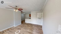 Located at 5011 S Alston Ave in Durham, NC, this single-floor residence offers 2 bedrooms and 3 bathrooms within a thoughtfully arranged layout. The kitchen is a functional centerpiece, featuring warm oak cabinetry, granite-style countertops, stainless steel appliances including a dishwasher and refrigerator, and durable wood-look flooring. A peninsula provides additional counter space and separates the kitchen from the adjoining living area. The living room is bright and welcoming, complete with crown molding, a ceiling fan, hardwood-style flooring, and a sliding glass door that opens to the outdoors, filling the space with natural light. Both bedrooms are carpeted and offer a comfortable, quiet retreat, each with windows that bring in natural light and views of the surrounding greenery. The primary bedroom includes a ceiling fan and crown molding detail. The three bathrooms are clean and functional, with one featuring a full tub-shower combination. Additional storage is available through a dedicated closet. Textured ceilings are consistent throughout the home, and neutral wall tones create a cohesive, move-in-ready aesthetic throughout every room.