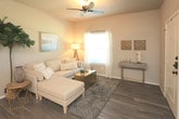 Located at 6610 34th St in Lubbock, Texas, this single-story residence offers a thoughtfully designed layout with warm, neutral tones and quality finishes throughout. The living room serves as a welcoming centerpiece, featuring rich wood-look flooring, a ceiling fan, and arched window details that allow natural light to fill the space. The open, relaxed atmosphere is well-suited for both everyday living and entertaining.

The kitchen is equipped with dark espresso cabinetry, granite-style countertops, and a full suite of stainless steel appliances, including a refrigerator, electric range, and built-in microwave. The wood-look flooring continues here, creating a cohesive flow between spaces.

The bedrooms are carpeted for comfort and offer generous proportions. Each room benefits from multiple windows dressed with blinds and sheer curtains, allowing for ample natural light and a serene ambiance. Closet access is visible in the primary bedroom, providing practical storage.

The bathroom features wood-look flooring, dark cabinetry with a granite-top vanity, a framed mirror, and lighted wall sconces, delivering a clean and modern aesthetic. Overall, this residence presents a consistent design sensibility, combining functional layouts with contemporary finishes for comfortable everyday living.