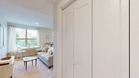 Located at 2724 11th St NW in Washington, DC's vibrant Columbia Heights neighborhood, this single-floor unit offers five bedrooms and two full bathrooms within a thoughtfully designed layout. The open-concept kitchen and living area serves as the heart of the home, featuring white shaker cabinets, granite countertops, a full suite of stainless steel appliances — including a refrigerator, range, microwave, and dishwasher — and light hardwood flooring that extends throughout the unit. The living area provides a comfortable gathering space with natural light streaming in through large windows. Each of the five bedrooms is finished with the same warm hardwood floors and crisp white walls, with several rooms offering windows with views of the surrounding streetscape and greenery. The two bathrooms are modern and well-appointed: one features a tiled tub-shower combination with a white vanity, while the second offers a glass-enclosed walk-in shower, also finished with large-format grey tile and a matching white vanity. Recessed lighting throughout maintains a clean, contemporary aesthetic. A connecting hallway ties all rooms together efficiently, maximizing the use of the available floor space across this well-designed urban residence.