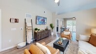 Located at 6102 Vermillion Cedar Way in Kannapolis, NC, this single-story home offers a thoughtfully designed layout with one bedroom, two full bathrooms, and two closets. The open-concept living area immediately impresses with soaring vaulted ceilings and warm wood-look flooring that flows throughout the main spaces. Natural light pours in through large windows and a sliding glass door, which opens to an outdoor area, creating a bright and welcoming ambiance.

The kitchen is a functional showpiece, featuring rich dark espresso cabinetry, granite countertops, stainless steel appliances, a deep undermount sink, and pendant lighting — all designed for both style and practicality. It connects seamlessly to the living and dining areas, making the space ideal for entertaining.

The bedroom offers a comfortable retreat with plush carpet, a ceiling fan, and a dedicated closet. The neutral tones and natural light from a large window contribute to a calm, restful atmosphere.

Both bathrooms are finished consistently with dark cabinetry, granite countertops, and wood-look flooring. One features a soaking tub with shower combination, while the other includes a walk-in shower, offering versatility for daily use.

Overall, the home presents a clean, modern aesthetic with quality finishes throughout.