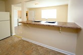 Located at 21 Sacramento Drive in Hampton, Virginia, this two-story home offers a practical and comfortable layout across two levels. The main floor features tile flooring throughout, beginning with a spacious living area filled with natural light from multiple windows and a staircase leading to the upper level. Adjacent to the living space, the kitchen is well-equipped with warm wood cabinetry, laminate countertops, a full suite of appliances including a refrigerator, electric range, and dishwasher, and a pass-through counter that connects to the main living area. A dedicated laundry area with a washer and dryer is conveniently located on the main floor. A full bathroom on this level features a tub with a decorative shower curtain and a vanity with a large mirror. The upper level houses the bedrooms, each carpeted and bathed in natural light from well-placed windows. The primary bedroom is notably spacious and includes a walk-in closet. An additional bathroom upstairs features a clean vanity setup with ample counter space and a large mirror. Throughout the home, neutral wall tones and consistent finishes create a cohesive and move-in-ready atmosphere.