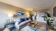 Located at 2500 E James Ave in Baytown, Texas, this single-story, 3-bedroom, 1-bathroom home offers a practical and comfortable layout across its thoughtfully organized floor plan. The living room serves as the heart of the home, featuring wood-look flooring, a ceiling fan, and natural light from a front-facing window with blinds and navy curtains. The galley-style kitchen is equipped with white cabinetry, dark granite countertops, a tile backsplash, black appliances including a gas range and refrigerator, and direct sight lines into the living area. The primary bedroom features plush carpeting, a ceiling fan, and natural window light, while the additional bedrooms offer comparable comfort — one notably includes a window workspace area with access to an adjoining room. All bedrooms are fitted with ceiling fans for year-round comfort. The shared bathroom includes a tub-shower combination with classic white tile surround, wood-look flooring, and a decorative mirror. A dedicated laundry area accommodates a full-size washer and dryer with overhead shelving for additional storage. Throughout the home, neutral gray walls and consistent finishes create a cohesive, move-in-ready aesthetic.