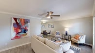This well-appointed 1-bedroom, 1-bathroom residence is laid out across a single floor, offering a comfortable and cohesive living experience. The open living and dining area serves as the heart of the home, featuring wood-style plank flooring, crown molding, and a ceiling fan with light fixture. Large windows dressed with blinds allow natural light to fill the space while offering outdoor views, creating a bright and welcoming atmosphere throughout.

The galley-style kitchen is efficiently designed with white cabinetry, brushed nickel hardware, tile backsplash, white countertops, a double stainless steel sink, and a stainless steel refrigerator. It opens conveniently toward the dining area, making the space practical for everyday living.

The bedroom is a restful retreat, carpeted for comfort and equipped with a ceiling fan, multiple windows that invite natural light, and access to a closet. The neutral color palette and soft tones create a calm, relaxing environment.

The bathroom features a white vanity with a single sink, mirrored medicine cabinets providing ample storage, and a shower-tub combination with a stylish striped curtain. Clean white finishes keep the space feeling fresh and functional.

Throughout the unit, warm neutral tones, consistent finishes, and thoughtful details combine to create a cohesive, move-in-ready living space.