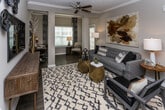 This single-floor residence at 6038 Hixson Pike in Hixson, Tennessee, offers a thoughtfully designed open-concept layout with contemporary finishes throughout. The kitchen serves as a central hub, featuring granite countertops, gray shaker-style cabinetry, stainless steel appliances, and a large peninsula with bar seating illuminated by pendant lighting. It flows directly into the dining area, which is distinguished by crown molding, a chandelier, and an accent wall, creating an elegant yet functional space for entertaining.

The living room provides a comfortable gathering space with a ceiling fan, textured accent wall, and natural light from multiple windows. An adjacent flex area functions as a home office or sitting room. The bedrooms are carpeted and well-sized, each featuring ceiling fans and ample natural light. The bathrooms are finished with granite-topped vanities, gray cabinetry, and wood-look flooring. A dedicated laundry area with full-size washer and dryer hookups adds everyday practicality. Throughout the residence, warm-toned walls, wood-look flooring in main living areas, and consistent modern detailing create a cohesive and inviting atmosphere.