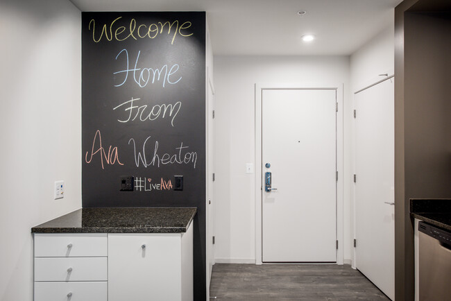 Apartment entry with hard surface flooring and chalkboard wall - AVA Wheaton