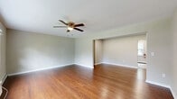 Located at 67 Country Club Rd in Eatontown, NJ, this well-appointed 2-bedroom, 1-bathroom residence offers a thoughtful single-floor layout designed for comfortable living. Rich hardwood flooring flows throughout the main living areas and bedrooms, lending warmth and continuity to the space.

The spacious living room is a standout, featuring a ceiling fan and an open sightline that connects seamlessly to the entryway. The kitchen has been tastefully updated with dark espresso cabinetry, light stone countertops, light vinyl plank flooring, and a full suite of stainless steel appliances, including a refrigerator and electric range.

The generously sized primary bedroom is filled with natural light from a wide triple-pane window overlooking the greenery outside, and is equipped with a ceiling fan and baseboard heating. The second bedroom also features hardwood floors, a ceiling fan, a closet, and its own window with outdoor views. Both rooms offer a calm, neutral palette ideal for restful living.

The bathroom is cleanly finished with a modern vanity, white countertop, and a mirrored medicine cabinet. A central hallway with recessed lighting connects all rooms efficiently. The kitchen area includes an additional exterior door and window, providing added natural light and convenient access.