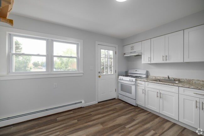 Discover the inviting interiors of Pinewood Apartments, featuring a modern kitchen with sleek finishes and ample natural light. Experience comfort and style in a welcoming environment. Schedule your tour today and make Pinewood your new home! - Pinewood Apartments