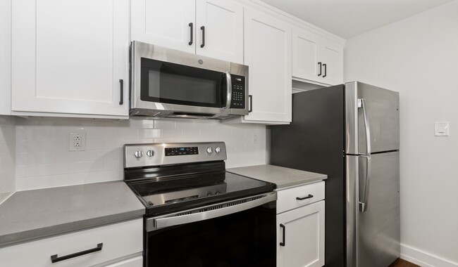 Modern kitchens with stainless steel appliances - The Left Bank Apartments